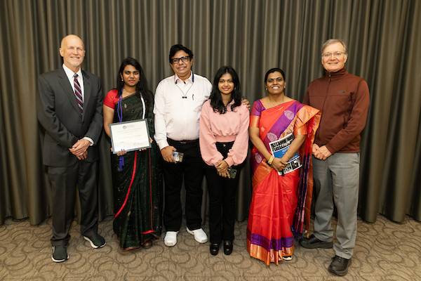 Dr. Jeffrey Potteiger (left), Varsha Jawahar and her family